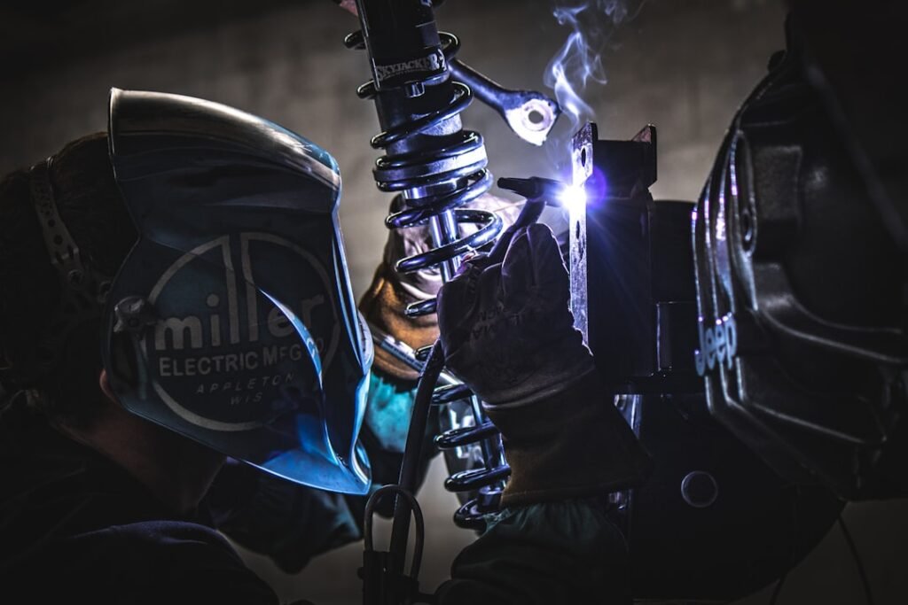 Um Homem Usando Um Capacete E Equipamento De Soldadura vY WNTNfXR0