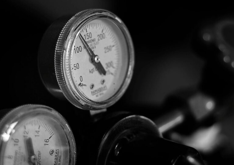 Monochrome image of an industrial pressure gauge showing detailed measurements.