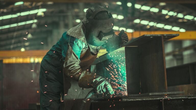 A welder working in a factory, sparks flying from the welding process.
